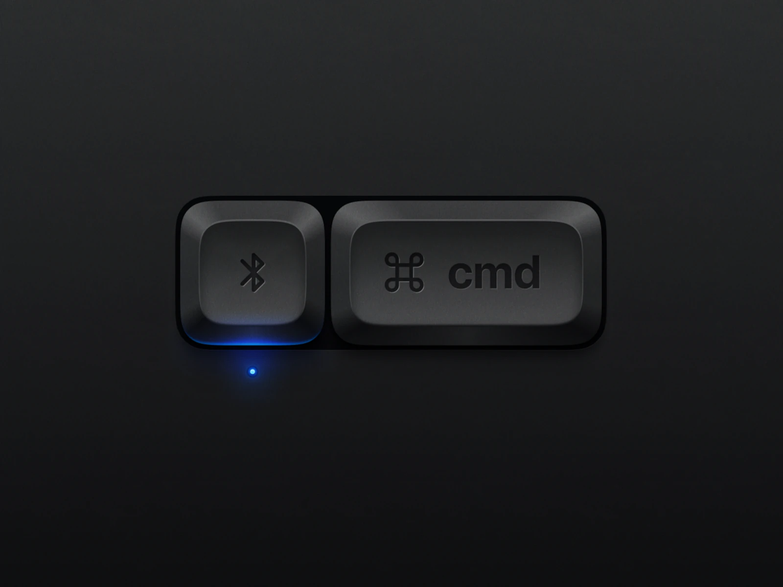A dark Bluetooth key and Command key set in a recessed well, with a blue lamp glowing under the left cap.